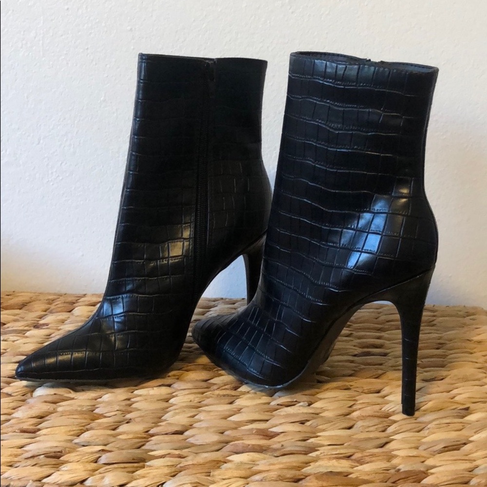 Black faux leather stiletto boots.